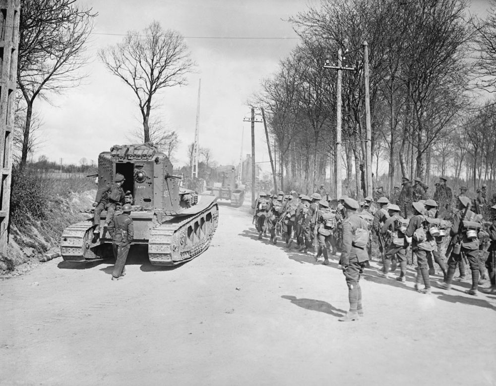 New Zealand infantry march alongside Whippet Tanks of the 3rd Battalion at Mailly-Maillet. 26 March 1918.